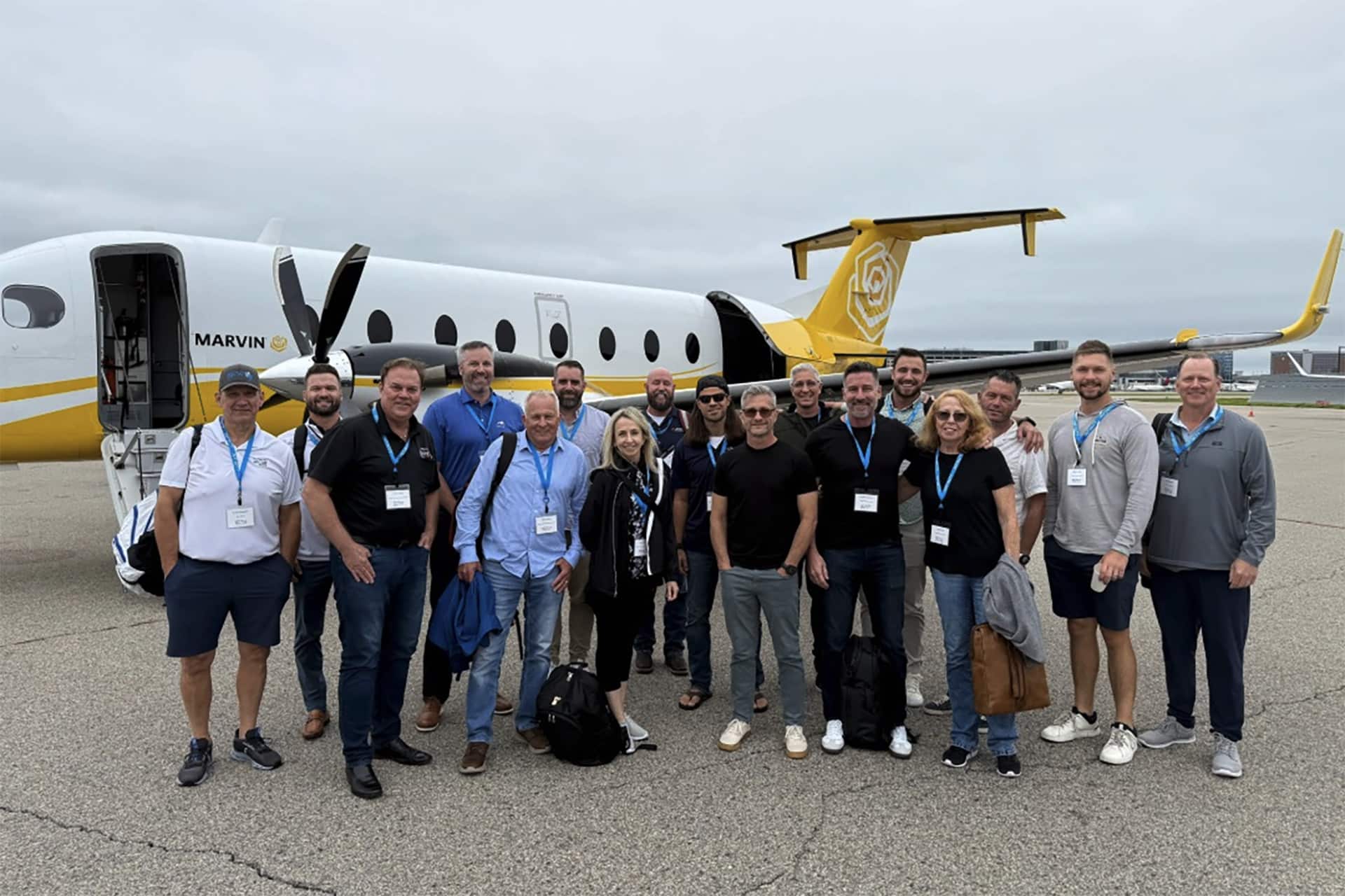 Master Craftsmen team next to plane