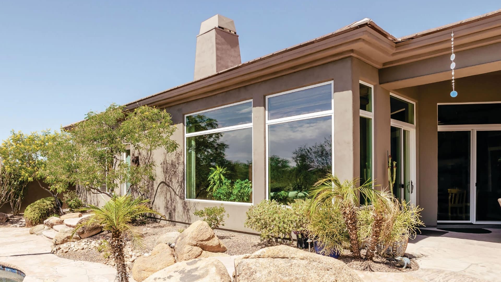 Large replacement windows on a desert-landscaped Las Vegas home in full sun